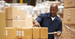 Man checking labels on fulfillment boxes