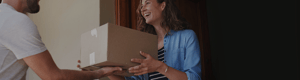 Smiling woman as a box is delivered to her at her front door